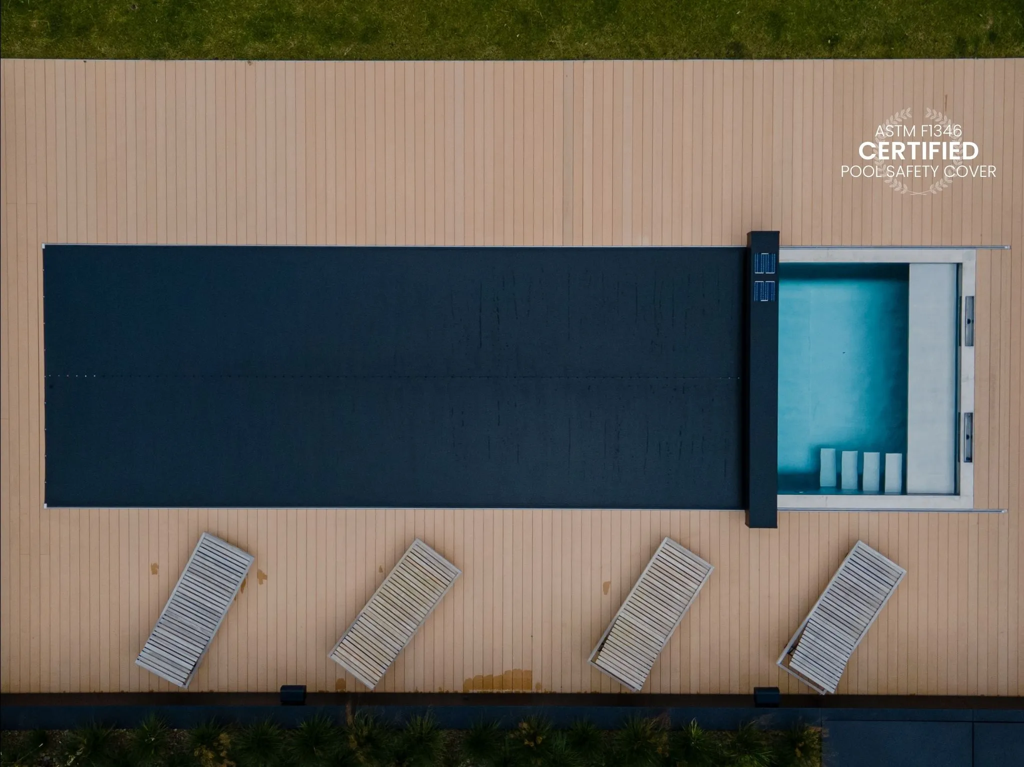 A pool covered with a black coverseal, an automatic safety pool cover