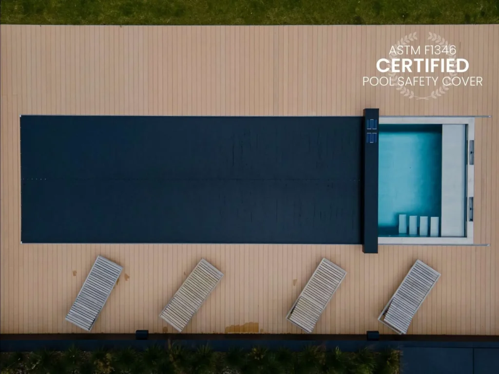 A pool covered with a black coverseal, an automatic safety pool cover