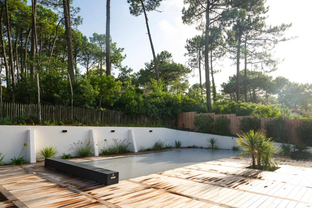 A black coverseal - safety pool cover o a wooden pool deck