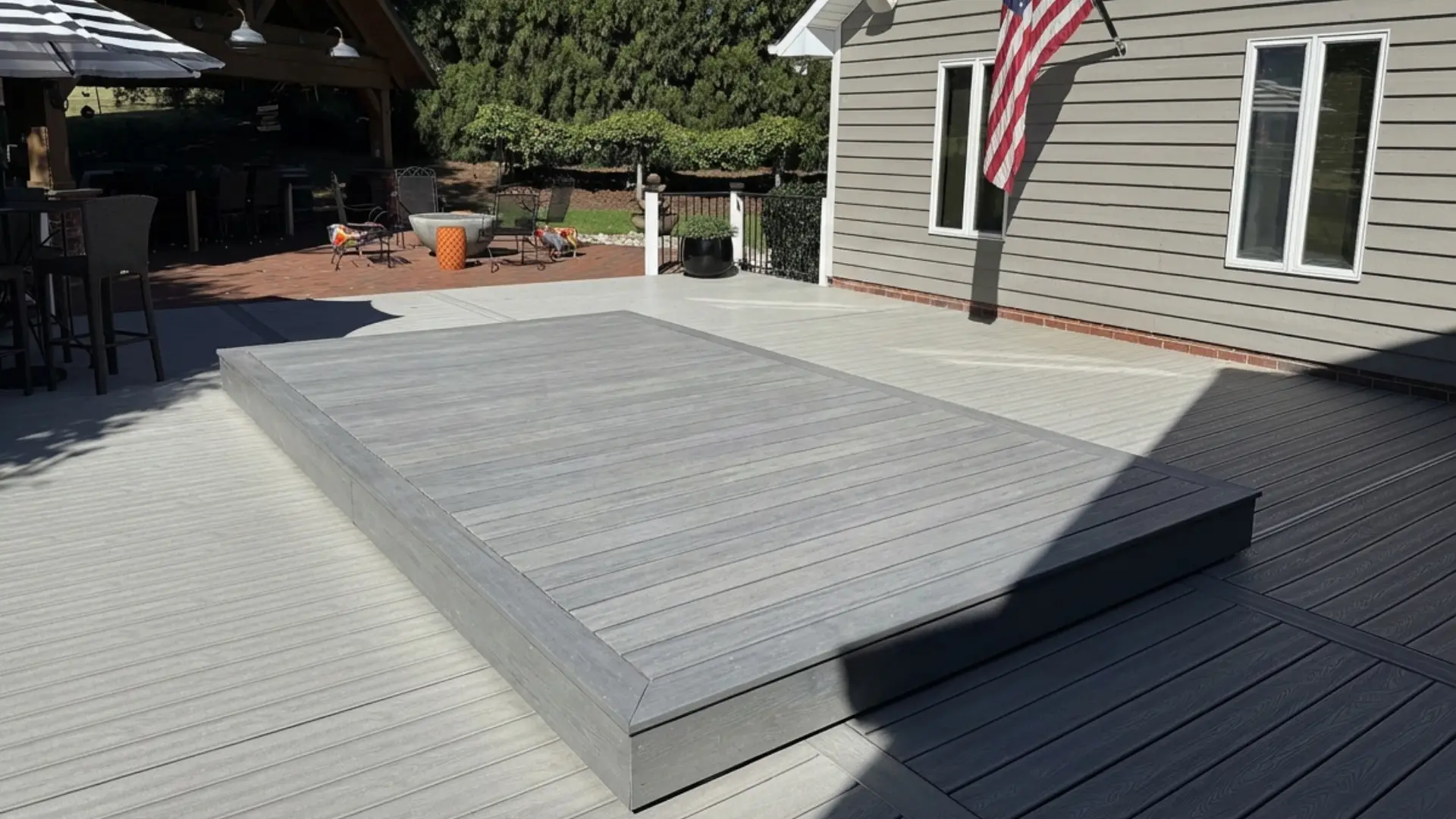 S-LIDE - Sliding Deck Pool Cover covered with gray composite decking