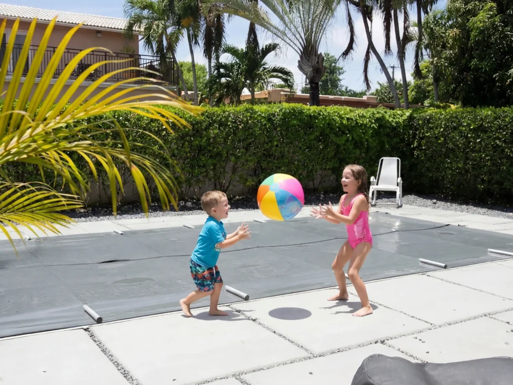 Kids playing by the pool but it is covered with an ASTM F1346 certified cover