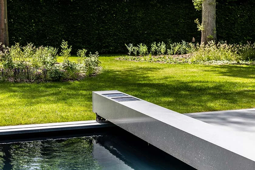 - COVERSEAL automatic safety pool cover closed over a residential swimming pool during routine care and inspection