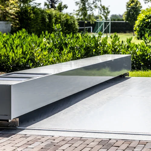 Automatic pool cover showing uneven movement and incomplete closure during a maintenance inspection